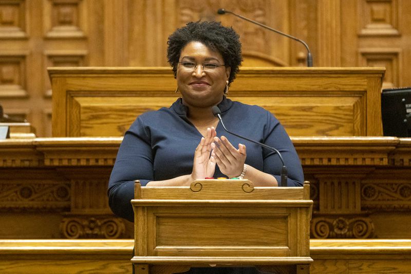 Georgia Democrat Stacey Abrams joins in applause after she and other members of Georgias Electoral College cast their ballots in the Georgia Senate Chambers at the Georgia State Capitol building in December 2020.  (Alyssa Pointer / Alyssa.Pointer@ajc.com)