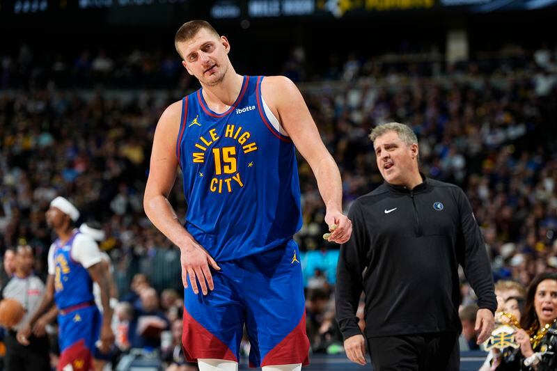 Denver Nuggets center Nikola Jokic (15) walks away from Minnesota Timberwolves assistant coach Micah Nori after a brief exchange in the second half of Game 1 of an NBA basketball second-round playoff series Saturday, May 4, 2024, in Denver. (AP Photo/David Zalubowski)