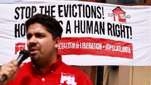 Estevan Herbnandez speaks during a rally alongside tenants of Forest at Columbia Apartments outside of the DeKalb Government Building on Thursday, July 28, 2022. (Natrice Miller/natrice.miller@ajc.com)
