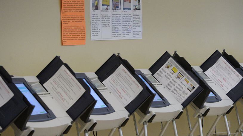 Empty voting machines line the wall inside the Fulton County Government Center in Atlanta on Tuesday, Oct. 22, 2013.