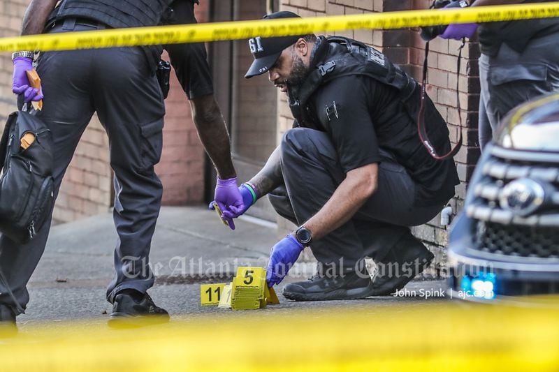 Atlanta police collect evidence from the scene of a double shooting at the intersection of Edgewood Avenue and William H. Borders Sr. Drive on Friday morning.