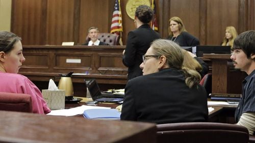 In one of only a few times that she looked in her husband’s direction, Jamie Cason Whited briefly confers with Justin Whited’s attorney, Donna Clement, after they both agreed to end life support for their daughter, Dinah Paige Whited. The parents of the badly abused infant agreed on Wednesday, Aug. 3, 2016, to remove her from life support, a decision that could mean the charges against the baby’s father escalate to murder. The agreement came after an unusual five-minute meeting between Justin and Jamie Cason Whited at the Walton County Courthouse where a hearing was held to determine the baby’s fate. BOB ANDRES / BANDRES@AJC.COM