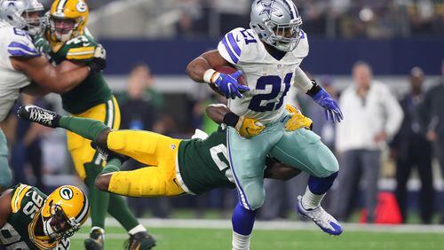 Ezekiel Elliott of the  Cowboys carries the ball against the Packers in an NFC Divisional Playoff game at AT&T Stadium on January 15 in Arlington, Texas.