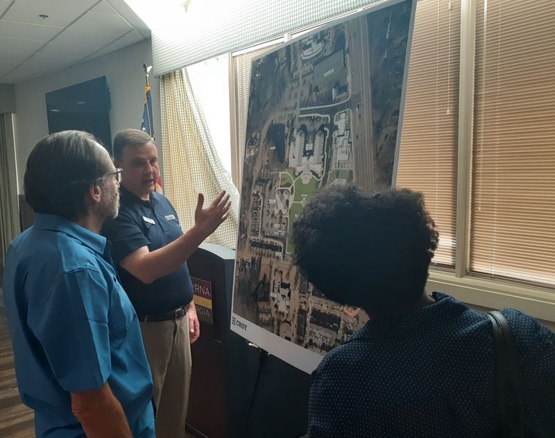Greg Teague, center, president of Croy Engineering, shows residents Smyrna's downtown redevelopment plan during a public hearing inside the Smyrna Community Center on Monday, June 14, 2021. Smyrna is putting the finishing touches on a blueprint that would add green space and make the city's downtown corridor more pedestrian friendly. (Photo by Matt Bruce/for the AJC)