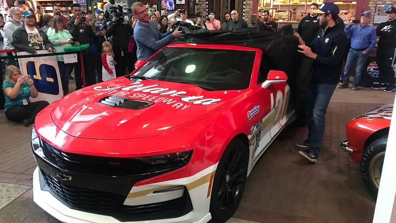 NASCAR driver Chase Elliott, right, and Brandon Hutchison, left, unveil the pace car for this year's Folds of Honor QuikTrip 500 at Atlanta Motor Speedway on March 15, 2020. Hutchison is president of AMS. (Photo by Zach Koons/AJC)