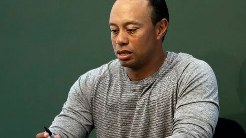 In this March 20, 2017, file photo, Tiger Woods prepares to sign copies of his new book at a book signing in New York. Police say Woods has been arrested on a DUI charge in Florida. (AP photo)