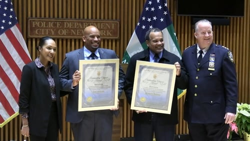 Axel and Kenny Dodson, retired New York Police Department officers, were presented with the Outstanding Citizens Award for their quick actions to detain a woman accused of trying to burn down Martin Luther King Jr.'s birth home in Atlanta on Thursday.