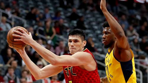 Atlanta Hawks' Ersan Ilyasova, left, moves to the hoop against Indiana Pacers' Thaddeus Young in the first quarter of an NBA basketball game in Atlanta, Wednesday, Dec. 20, 2017. (AP Photo/David Goldman)