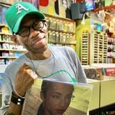 Darryl Harris, owner of Moods Music in Little Five Points, holds one of his favorite albums, Sade’s “Stronger Than Pride” while preparing for Record Store Day. (Photo Courtesy of Dyana Bagby)