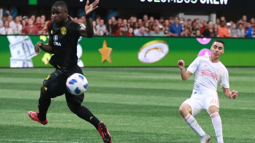 Atlanta United midfielder Miguel Almiron scores a goal past Columbus Crew defender Jonathan Mensah for a 3-1 victory during the second half in a MLS soccer match on Sunday, August 19, 2018, in Atlanta.  Curtis Compton/ccompton@ajc.com