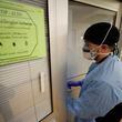 A registered nurse in full personal protective equipment enters a room to provide care to a patient with COVID-19 on Monday, February 5, 2024, Miguel Martinez /miguel.martinezjimenez@ajc.com.