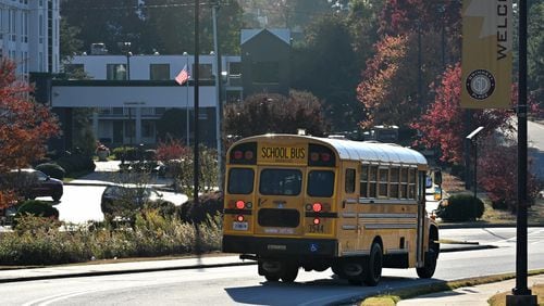A Gwinnett school bus makes its way for drop offs on Nov. 7. (Hyosub Shin / Hyosub.Shin@ajc.com)