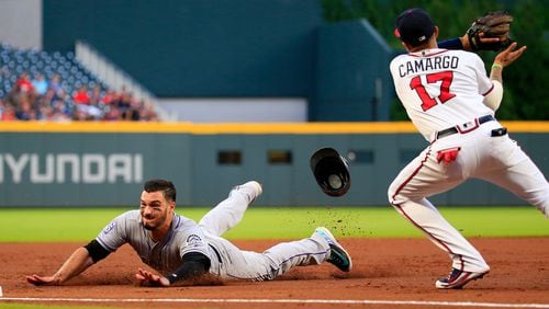 Nolan Arenado of the Colorado Rockies slides into third safely before the tag by Johan Camargo  of the Atlanta Braves during the second inning at SunTrust Park on August 16, 2018 in Atlanta, Georgia. (Photo by Daniel Shirey/Getty Images)