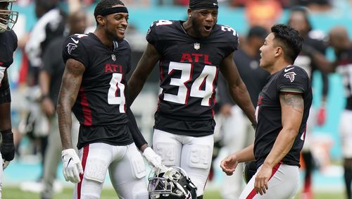 Falcons wide receiver Tajae Sharpe (4) and cornerback Darren Hall (34) congratulate kicker Younghoe Koo (7) after he kicked the game-winning field goal in the closing seconds against the Miami Dolphins, Sunday, Oct. 24, 2021, in Miami Gardens, Fla. The Falcons won 30-28. (Wilfredo Lee/AP)