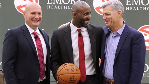 Atlanta Hawks general manager Travis Schlenk (left) and owner Tony Ressler (right) introduce Lloyd Pierce as the 13th full-time coach in the Atlanta history of the NBA basketball franchise on Monday, May 14, 2018, in Atlanta.