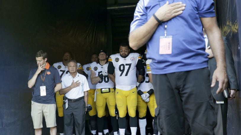 Pittsburgh Steelers players stand in the tunnel during the playing of the national anthem before an NFL football game against the Chicago Bears, Sunday, Sept. 24, 2017, in Chicago. (AP Photo/Nam Y. Huh)