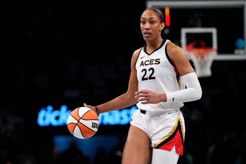 FILE - Las Vegas Aces' A'ja Wilson (22) looks to pass during the first half in Game 3 of a WNBA basketball final playoff series against the New York Liberty Sunday, Oct. 15, 2023, in New York. Wilson, Breanna Stewart and Brittney Griner will be back on the courts chasing another WNBA title when camps open on Sunday, April 28. (AP Photo/Frank Franklin II, File)