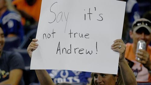 An Indianapolis Colts fan holds up a sign after sports reporter Adam Schefter tweeted that quarterback Andrew Luck was planning on retiring during the fourth quarter of the game between the Chicago Bears and the Indianapolis Colts at Lucas Oil Stadium on Aug. 24, 2019, in Indianapolis. BOBBY ELLIS / GETTY IMAGES