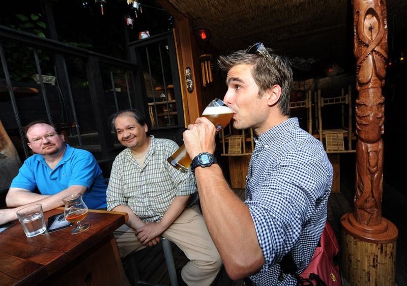  Chef Hugh Acheson, drinks a beer on the back patio of the The Bookhouse Pub in 2010. / AJC file photo