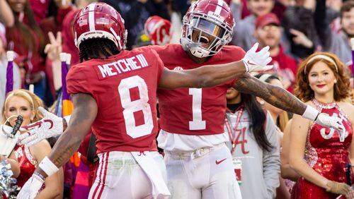 Alabama wide receiver Jameson Williams (1) celebrate this second touchdown reception with wide receiver John Metchie III (8) during the first half of an NCAA college football game against Arkansas, Saturday, Nov. 20, 2021, in Tuscaloosa, Ala. (AP Photo/Vasha Hunt)