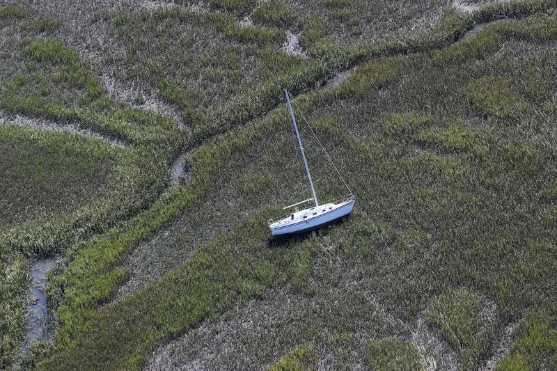 A sailboat has been blown lose from itâ€™s harbor anchor into the marsh at Shelman Bluff just south of Harris Neck along the Georgia coast in the aftermath of Hurricane Matthew on Sunday, Oct. 9, 2016. Curtis Compton /ccompton@ajc.com