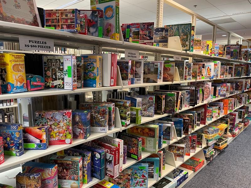 The Peachtree City Library in Peachtree City has a long row of shelves filled with puzzles of different shapes, sizes and difficulty levels. (Courtesy of Kathy Dean)