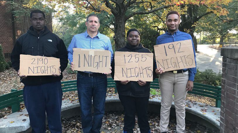 Ben Deutsch with youth involved in Covenant House Georgia's programs. They're holding signs showing how long they were homeless.