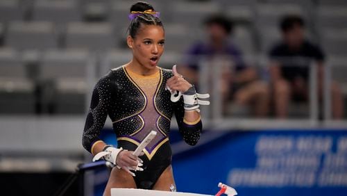 LSU's Haleigh Bryant gestures to teammates standing nearby as she prepares to compete on the uneven bars during the NCAA women's gymnastics championships in Fort Worth, Texas, Thursday, April 18, 2024. (AP Photo/Tony Gutierrez)