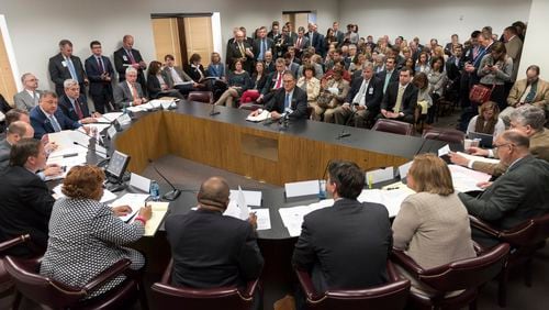 Lawmakers and lobbyists get ready for a Senate Finance Committee meeting last March. DAVID BARNES / DAVID.BARNES@AJC.COM