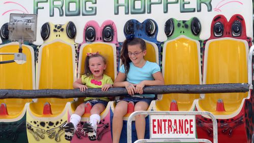 Hope Mattson, 4, rides the "Frog Hopper" with her cousin Savannah Meeler (9) at the Gwinnett County Fair in Lawrenceville in this AJC file phot0.