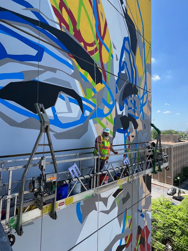 Joe Dreher takes a breather during work on the Midtown Union mural.