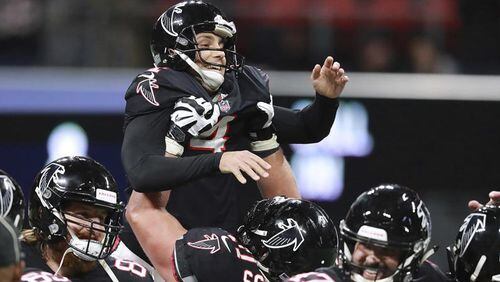 Falcons offensive lineman Ryan Schraeder hoists replacement kicker Giorgio Tavecchio in the air after his third field goal against the New York Giants on Monday, Oct 22, 2018, in Atlanta. -- Curtis Compton/Atlanta Journal-Constitution