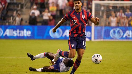 U.S. defender Miles Robinson (12), of Atlanta United, moves the ball past Haiti midfielder Derrick Ettiene Jr. (10) during the first half of a CONCACAF Gold Cup soccer match Sunday, July 11, 2021, in Kansas City, Kan. (Charlie Riedel/AP)