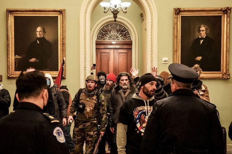 Robert Gieswein, left, in military garb, and Dominic Pezzola, center right, with a gray beard, confront Capitol Police officers at the U.S. Capitol in Washington on Jan. 6. Both men have been charged in connection with the Capitol riot. (Erin Schaff/The New York Times)