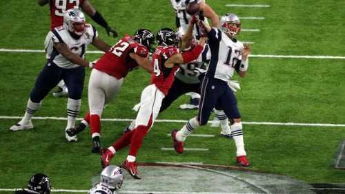 Atlanta Falcons outside linebacker Vic Beasley (44) hits New England Patriots quarterback Tom Brady (12) as he passes in the 2nd quarter Sunday. John Spink/AJC