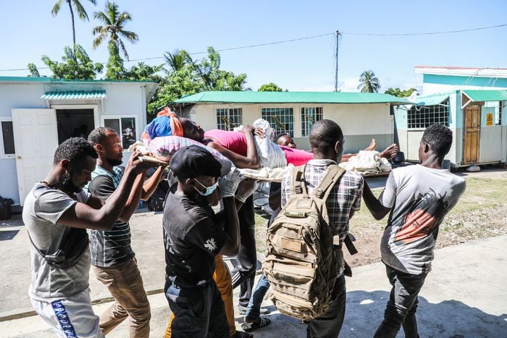 A woman wounded in an earthquake is carried on a stretcher at Cayes Airport to be transported to Port-au-Prince, Haiti, on Sunday, Aug, 15, 2021. (Valerie Baeriswyl/The New York Times)