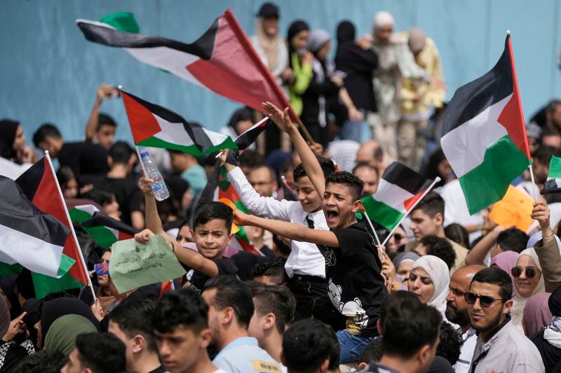 Protesters shout slogans against Israel and wave Palestinian flags during a sit-in in solidarity with the Palestinian people in Gaza in front of UNRWA office in Beirut, Lebanon, Thursday, April 18, 2024. Hundreds of Palestinian refugees protested Thursday outside the offices of the U.N. agency for Palestinian refugees in Beirut, expressing solidarity with fellow Palestinians in the Gaza Strip. (AP Photo/Hassan Ammar)