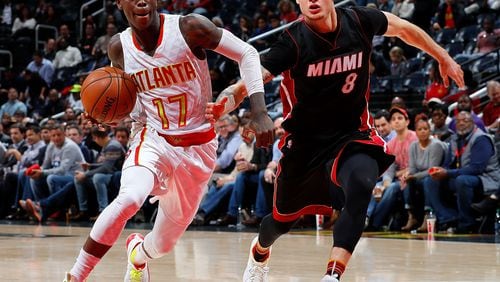 ATLANTA, GA - DECEMBER 07: Dennis Schroder #17 of the Atlanta Hawks drives against Tyler Johnson #8 of the Miami Heat at Philips Arena on December 7, 2016 in Atlanta, Georgia. NOTE TO USER User expressly acknowledges and agrees that, by downloading and or using this photograph, user is consenting to the terms and conditions of the Getty Images License Agreement. (Photo by Kevin C. Cox/Getty Images)