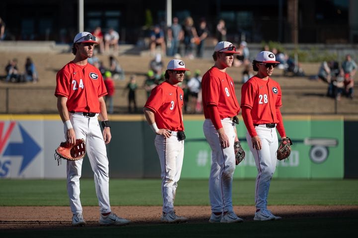 Bulldogs infielders look on as a pitcher warms up during the 20th Spring Classic game on Sunday at Coolray Field in Lawrenceville. (Jamie Spaar / for The Atlanta Journal-Constitution)