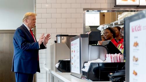 Republican presidential candidate former President Donald Trump, left, speaks to employees as he visits a Chick-fil-A eatery, Wednesday, April 10, 2024, in Atlanta. (AP Photo/Jason Allen)