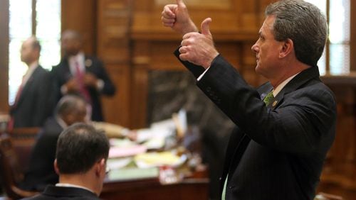 Then-state Sen. Buddy Carter signals which way his fellow Republicans should vote on a bill to require drug testing of some food stamp recipients during the last day of the legislative session on March 20, 2014. BEN GRAY / BGRAY@AJC.COM