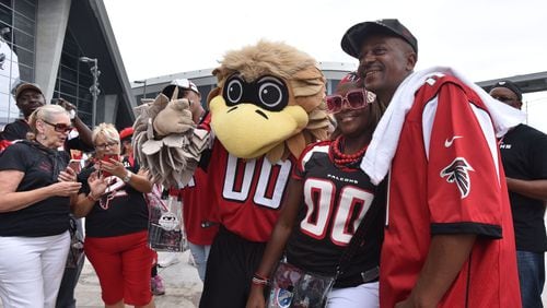 Freddie Falcon, seen here posing with fans at a game in 2017, will be at Chapel Hill Middle School to encourage an active lifestyle as part of the NFL’s Fuel Up to Play 60 program. HYOSUB SHIN / HSHIN@AJC.COM