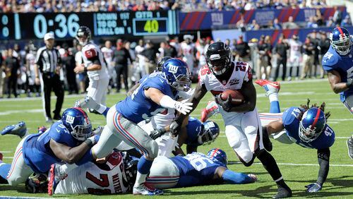 Atlanta Falcons running back Tevin Coleman (26) scores a touchdown against the New York Giants during the first half of an NFL football game, Sunday, Sept. 20, 2015, in East Rutherford, N.J. (AP Photo/Bill Kostroun)