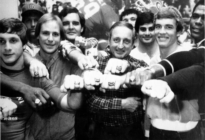 Georgia coach Vince Dooley, center, and a group of his Bulldogs display their 1980 national championship football rings presented to them Thursday in Atlanta. The Bulldogs went 12-0 in 1980 with a victory over Notre Dame in Sugar Bowl to give them the championship. (File photo)