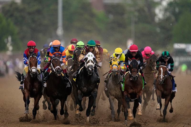 Brian Hernandez Jr. rides Mystik Dan, right, to the finish line to win the 150th running of the Kentucky Derby horse race at Churchill Downs Saturday, May 4, 2024, in Louisville, Ky. (AP Photo/Brynn Anderson)
