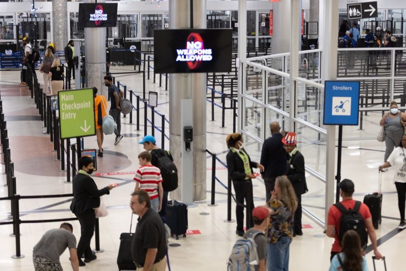 Passengers head through the security check at Hartsfield-Jackson Atlanta International Airport Friday, July 1, 2022. (Steve Schaefer / steve.schaefer@ajc.com)