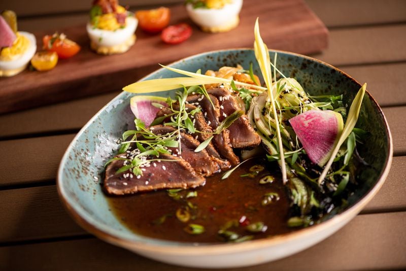 UP on the Roof's menu includes Pacific Rim flavors. This is Tuna Tataki with baby bok choy and chile-infused broth. (Mia Yakel for The Atlanta Journal-Constitution)
