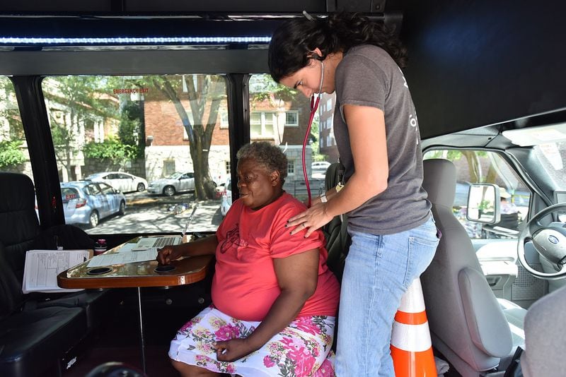 Mercy Care street medicine team member Joy Fernandez (nurse practitioner), checks on her client Sandra Hill at Mercy Community Church in Atlanta. (Hyosub Shin / Hyosub.Shin@ajc.com)
