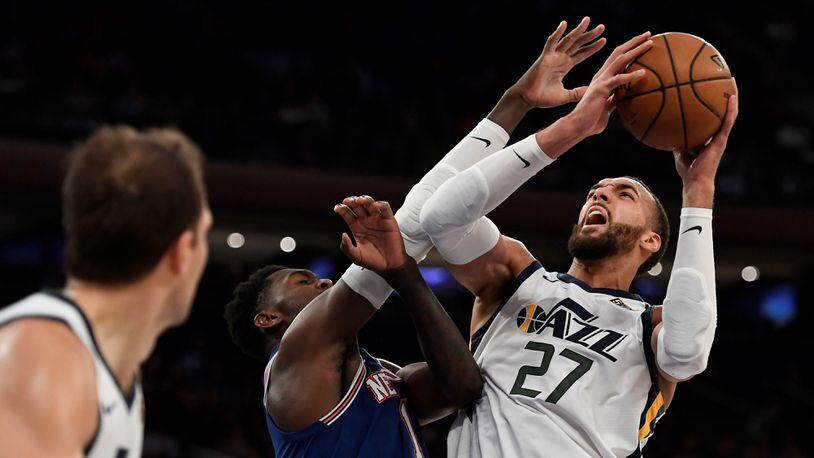 Utah Jazz center Rudy Gobert (27) shoots as New York Knicks forward Bobby Portis (1) defends during the second half of an NBA basketball game in New York, Wednesday, March 4, 2020. (AP Photo/Sarah Stier)