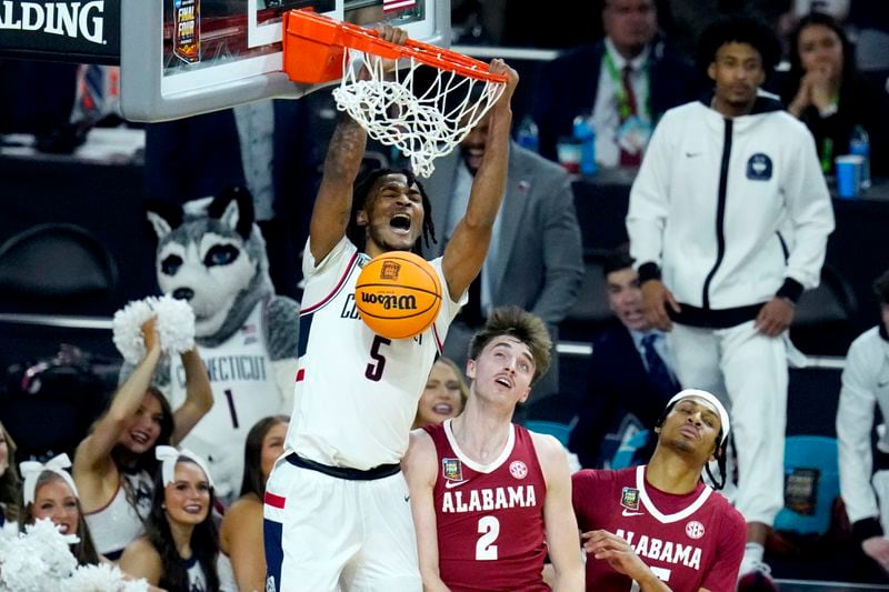 UConn guard Stephon Castle (5) dunks over Alabama forward Grant Nelson (2) during the second half of the NCAA college basketball game at the Final Four, Saturday, April 6, 2024, in Glendale, Ariz. (AP Photo/Ross D. Franklin)